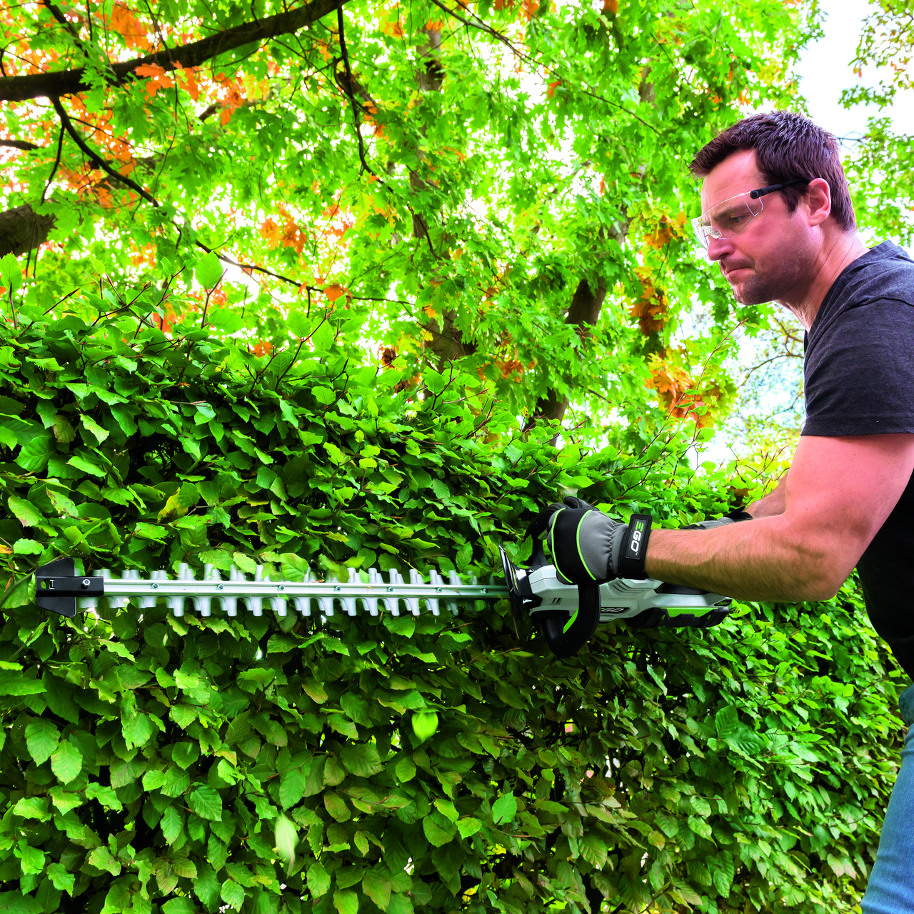 Man uses EGO hedge trimmer